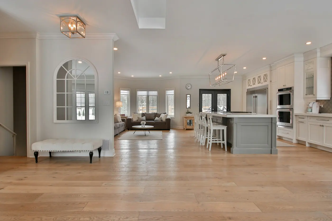 Large entry hall with refinished wide-plank oak floor and a curved staircase