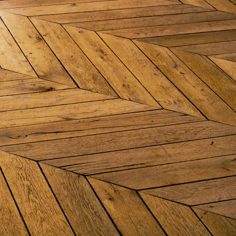 Oak herringbone floor meeting a parquet border