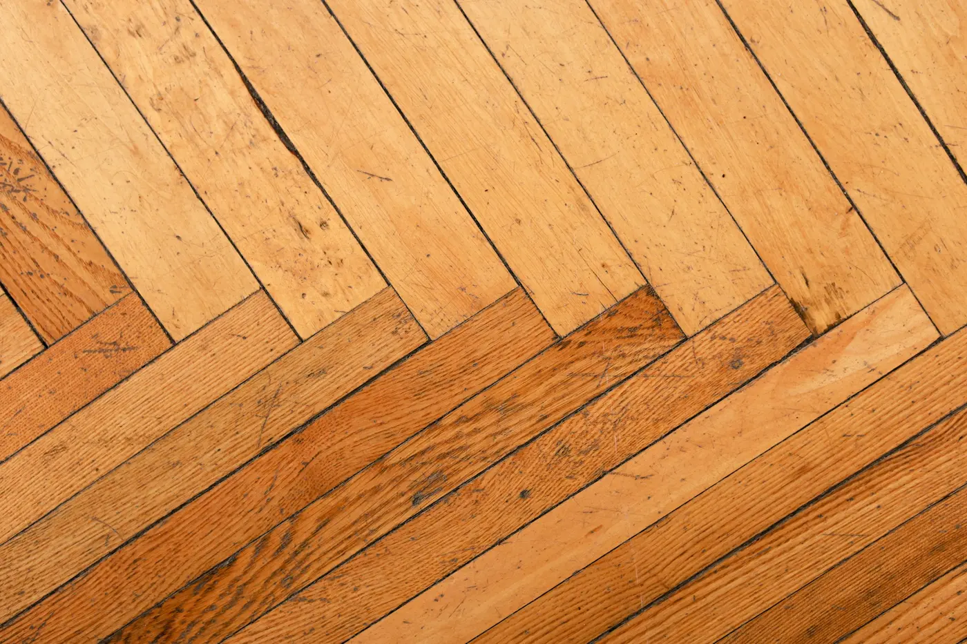 Refinished oak herringbone floor with a satin finish in low afternoon light