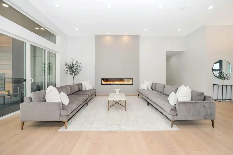 Bright living room with grey sofas on a pale oak floor