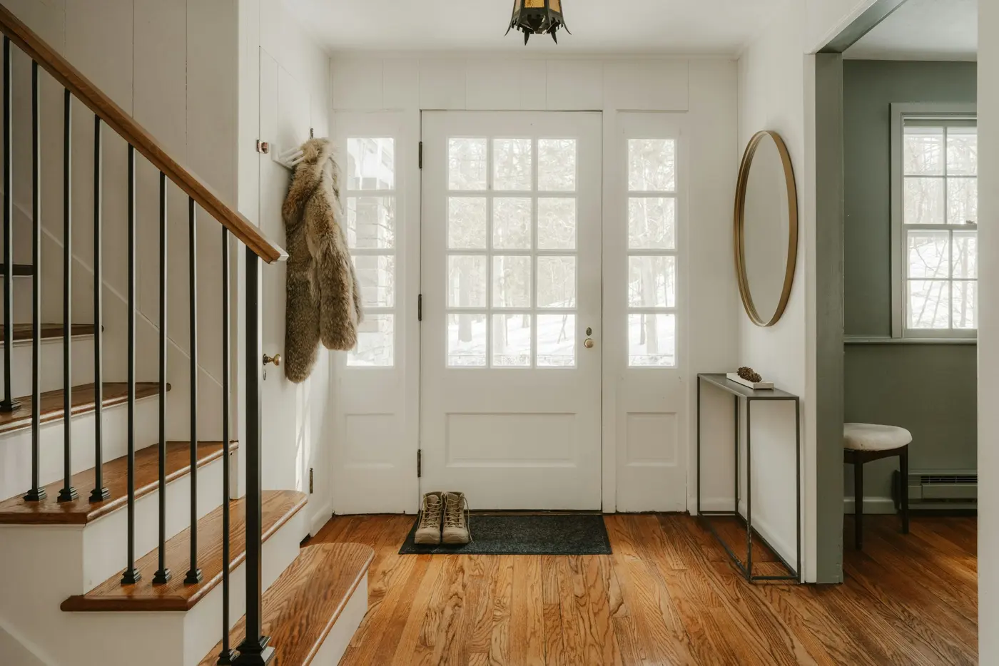 Front entry with a refinished oak floor and matching oak staircase with white risers